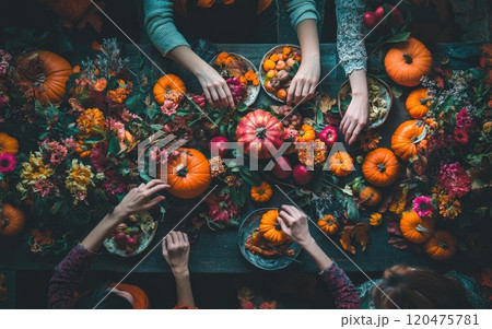 A group sits at a table filled with fruits and vegetables 120475781