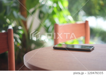 forget smartphone on a cafe table , lost smart phone forget smartphone on a cafe table , lost smart phone 120476335