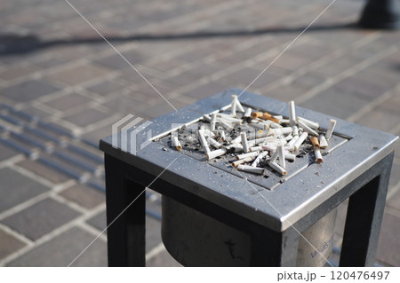 The collection of cigarette butts found in the outdoor ashtray on a public street The collection of cigarette butts found in the outdoor ashtray on a public street 120476497