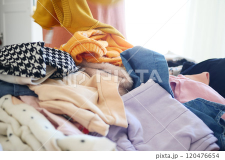 A Vibrant and Colorful Pile of Laundry Honestly Spread Out on a Cozy Bed in the Bedroom A Vibrant and Colorful Pile of Laundry Honestly Spread Out on a Cozy Bed in the Bedroom 120476654
