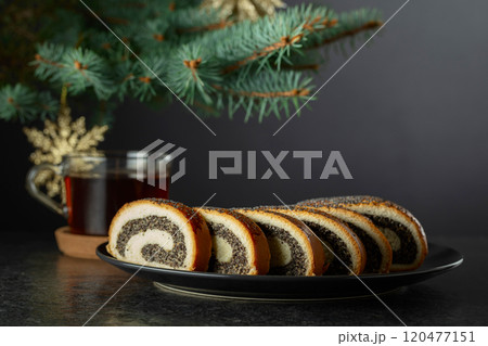 Poppy seed roll pieces on a background of Christmas tree. Poppy seed roll pieces on a background of Christmas tree. 120477151