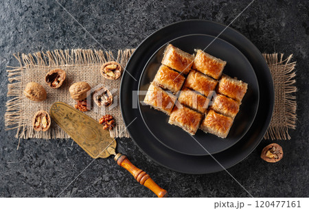 Baklava with walnuts on a blackstone table. Baklava with walnuts on a blackstone table. 120477161