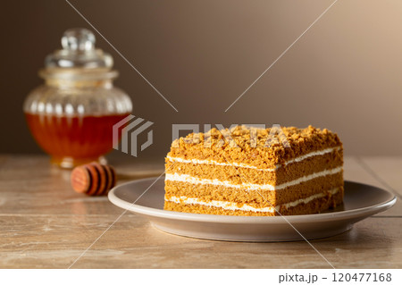 Traditional homemade honey cake on a beige background. Traditional homemade honey cake on a beige background. 120477168
