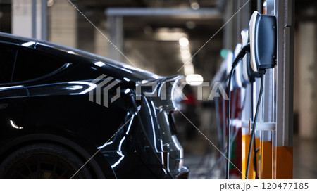 EV charger and electric car, Electric car charger station for charge ev battery, Plug for vehicle with electric engine, EV charger clean energy, Charging point at car parking lot department store. EV charger and electric car, Electric car charger station for charge ev battery, Plug for vehicle with electric engine, EV charger clean energy, Charging point at car parking lot department store. 120477185