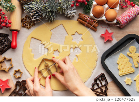 Pastry chef making christmas cookies using dough cutters Pastry chef making christmas cookies using dough cutters 120477628