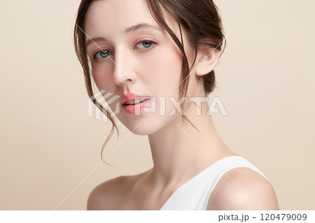 Beautiful young woman with clean fresh skin on beige background, Face care, Facial treatment, Cosmetology, beauty and spa, women portrait. 120479009