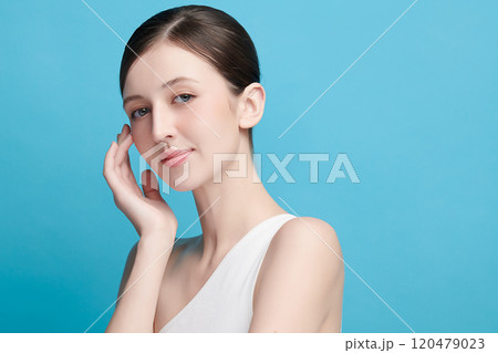 Beautiful young woman with clean fresh skin on blue background, Face care, Facial treatment, Cosmetology, beauty and spa, women portrait. 120479023