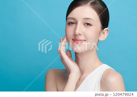 Beautiful young woman with clean fresh skin on blue background, Face care, Facial treatment, Cosmetology, beauty and spa, women portrait. 120479024