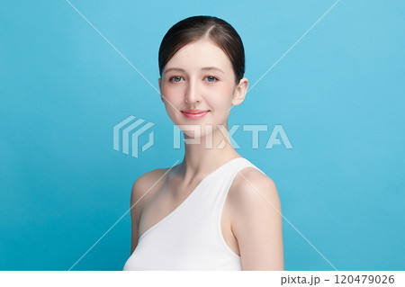 Beautiful young woman with clean fresh skin on blue background, Face care, Facial treatment, Cosmetology, beauty and spa, women portrait. 120479026