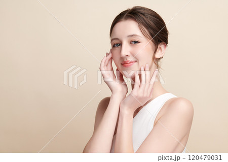 Beautiful young woman with clean fresh skin on beige background, Face care, Facial treatment, Cosmetology, beauty and spa, women portrait. 120479031