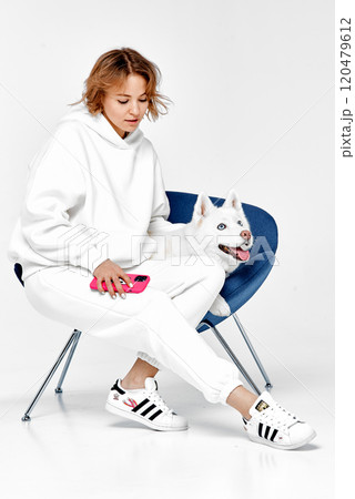 Woman and Husky Relaxing with Smartphone 120479612