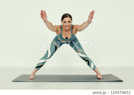 Wide-Legged Forward Fold Stretch Exercise. 120479652
