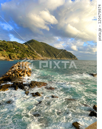 Waves break on breakwater of Mediterranean Sea. Nature of sea and mountains of Italy. Sunset in Setri Levante, Liguria. Waves break on breakwater of Mediterranean Sea. Nature of sea and mountains of Italy. Sunset in Setri Levante, Liguria. 120479974