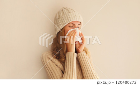 Sick exhausted young woman sneezing blow nose using tissue, unhealthy suffering girl feels unwell Sick exhausted young woman sneezing blow nose using tissue, unhealthy suffering girl feels unwell 120480272