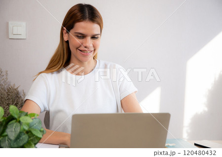 Happiness young businesswoman using laptop computer on desk in living room at home office. Happiness young businesswoman using laptop computer on desk in living room at home office. 120480432
