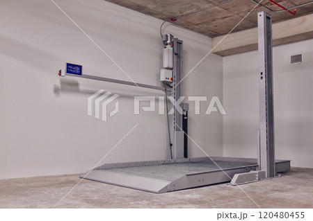 Empty Space in Automatic Elevator double stack car park. Hydraulic lift. Empty garage. Hydraulic machine for lifting car indoor parking. 120480455