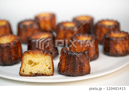 Canneles de bordeaux, traditional French sweet dessert with white table background 120481415