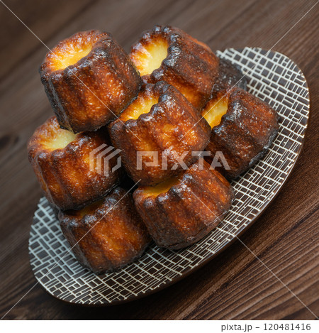 Canneles de bordeaux, traditional French sweet dessert with white table background Canneles de bordeaux, traditional French sweet dessert with white table background 120481416