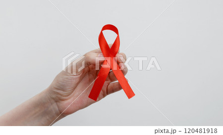 World AIDS Day. Woman holding red AIDS awareness ribbon 120481918
