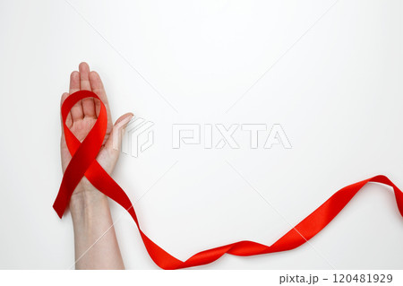 Woman holding red AIDS awareness ribbon. World AIDS Day 120481929