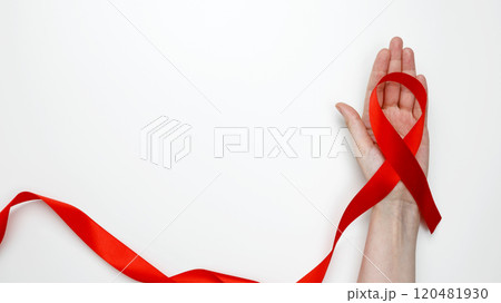 World AIDS Day. Woman holding red AIDS awareness ribbon 120481930