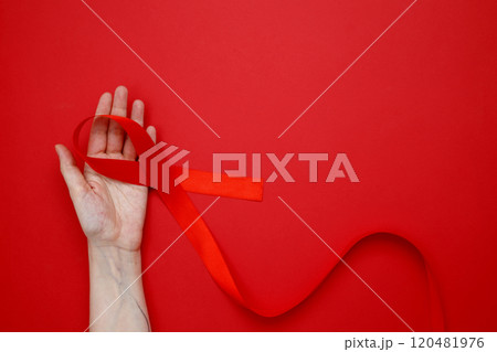 Woman holding red AIDS awareness ribbon. World AIDS Day Woman holding red AIDS awareness ribbon. World AIDS Day 120481976