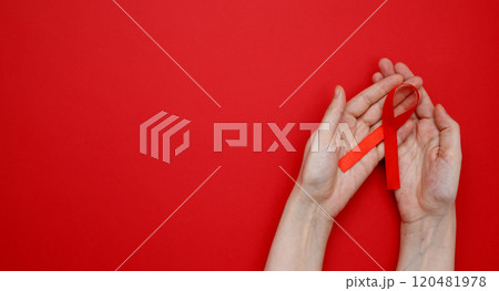World AIDS Day. Woman holding red AIDS awareness ribbon 120481978