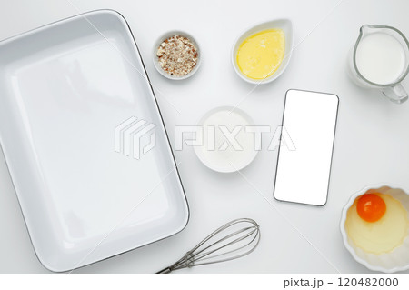 Cooking ingredients and smartphone with blank screen on a white background. Mockup design for recipe or food blog Cooking ingredients and smartphone with blank screen on a white background. Mockup design for recipe or food blog 120482000