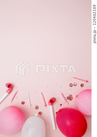 Birthday attributes colorful balloons, candles, and confetti. Concept of festive birthday celebrations 120482189