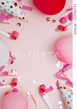 Concept of festive birthday celebrations. Birthday attributes colorful balloons, party hats, candles, and confetti 120482191