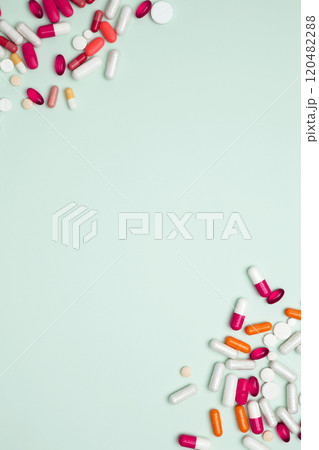 Concept of medicine, healthcare, and pharmaceutical industry. Various colorful pills and capsules scattered on a light blue background Concept of medicine, healthcare, and pharmaceutical industry. Various colorful pills and capsules scattered on a light blue background 120482288