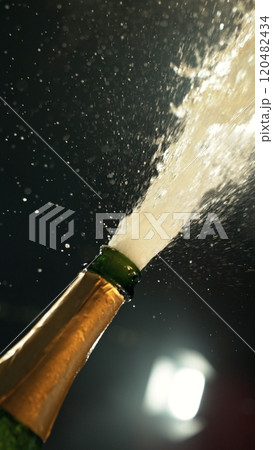 Celebration theme with splashing champagne on black background. 120482434