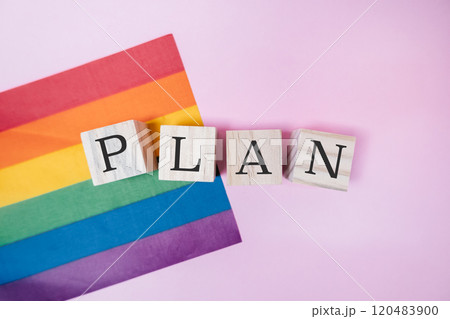 Rainbow flag and a wooden block with the word plan written on it Rainbow flag and a wooden block with the word plan written on it 120483900