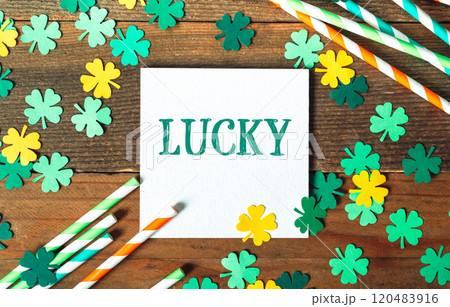 White sign with the word lucky written on it is surrounded by green White sign with the word lucky written on it is surrounded by green 120483916