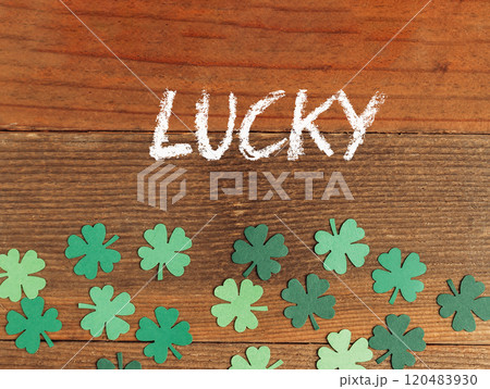 Wooden surface with green shamrocks and the word lucky Wooden surface with green shamrocks and the word lucky 120483930
