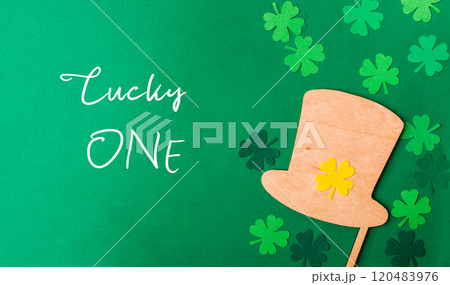 A green background with a wooden hat and four shamrocks A green background with a wooden hat and four shamrocks 120483976