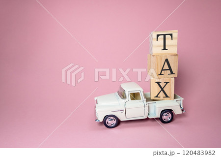 White truck is carrying a stack of wooden blocks on top of it 120483982