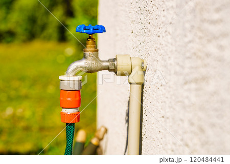 Garden tap with hosepipe attached. 120484441