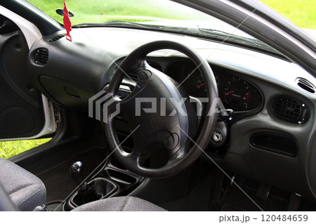 sleek classic white sedan parked on a grassy field, showcasing its elegant design and functionality in an outdoor environment sleek classic white sedan parked on a grassy field, showcasing its elegant design and functionality in an outdoor environment 120484659