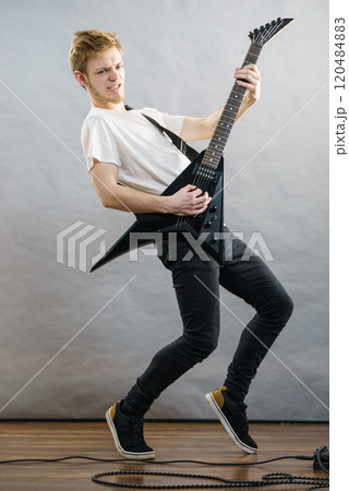 Man playing on electric guitar 120484883