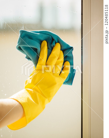 Hand cleaning window at home using detergent rag Hand cleaning window at home using detergent rag 120485118