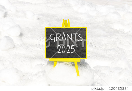 Planning grants 2025 new year symbol. Concept words Grants 2025 on beautiful yellow chalk blackboard. Beautiful white snow background. Business grants 2025 new year concept. Copy space. 120485884