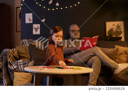Child Playing While Bearded Man Reading Book Child Playing While Bearded Man Reading Book 120486626