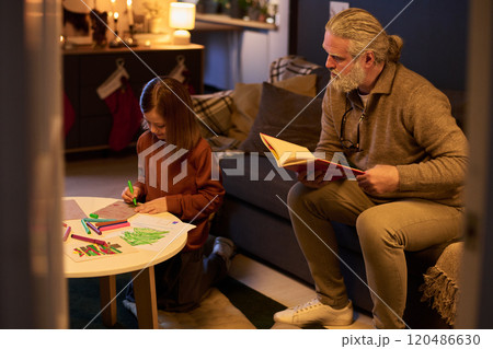 Reading Book with Child at Cozy Home Setting 120486630