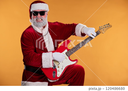 Santa Claus Playing Electric Guitar with Enthusiasm 120486680
