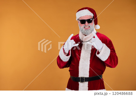 Santa Claus Pointing at Camera while Wearing Sunglasses Santa Claus Pointing at Camera while Wearing Sunglasses 120486688