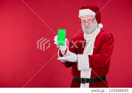 Portrait of Santa Claus Holding Smartphone with Red Background 120486695