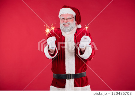 Portrait of Santa Claus Holding Sparklers and Smiling Portrait of Santa Claus Holding Sparklers and Smiling 120486708