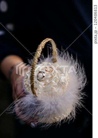 A person is holding a basket filled with beautiful wedding rings in it A person is holding a basket filled with beautiful wedding rings in it 120486813