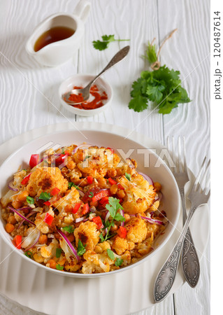 cauliflower chickpea quinoa salad in a white bowl 120487614